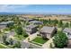 Stunning aerial view of a neighborhood featuring manicured lawns and mountain views in the background at 3419 Traver Dr, Broomfield, CO 80023