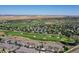 Wide aerial of a golf course community with a lake and apartment complexes with plenty of parking at 3419 Traver Dr, Broomfield, CO 80023