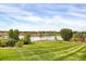 Picturesque backyard view showcasing a serene lake and well-maintained lawn and landscaping at 3419 Traver Dr, Broomfield, CO 80023