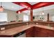 Bar with red trim, barstools, sink, and mini-refrigerator at 3419 Traver Dr, Broomfield, CO 80023