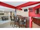 Basement bar with a TV, stools, and cabinets for storage at 3419 Traver Dr, Broomfield, CO 80023