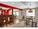 Basement bar with red and wood accents, bar stools, and a wine rack at 3419 Traver Dr, Broomfield, CO 80023