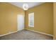 This bedroom features neutral carpet, a closet, a white light fixture, and a window at 3419 Traver Dr, Broomfield, CO 80023