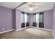 Bedroom with neutral carpet, light purple walls, and multiple windows at 3419 Traver Dr, Broomfield, CO 80023
