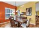 Elegant dining room with a large wooden table, modern chandelier, and stylish decor at 3419 Traver Dr, Broomfield, CO 80023