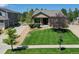 Well-manicured front yard with lush green lawn and landscaping leading up to a charming single-Gathering home at 3419 Traver Dr, Broomfield, CO 80023