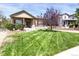 Charming single-Gathering home featuring manicured lawn, stone accents, and a welcoming covered front porch at 3419 Traver Dr, Broomfield, CO 80023