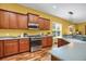 Well-lit kitchen featuring stainless steel appliances, wood floors, and wood cabinets at 3419 Traver Dr, Broomfield, CO 80023