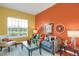 Bright living room with hardwood floors, stylish decor, and ample natural light through large window at 3419 Traver Dr, Broomfield, CO 80023