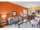 Open-concept living and dining area with vibrant walls, modern furniture, and hardwood flooring at 3419 Traver Dr, Broomfield, CO 80023