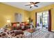Inviting living room with hardwood floors, decorative rug, and access to sunroom at 3419 Traver Dr, Broomfield, CO 80023