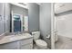 Clean bathroom features a quartz countertop, a modern sink, and a full tub with shower at 5229 Nighthawk Pkwy, Brighton, CO 80601