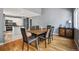 Open dining area with hardwood floors, modern lighting, and convenient access to the kitchen at 5229 Nighthawk Pkwy, Brighton, CO 80601