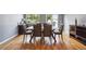 Elegant dining room featuring hardwood floors, a modern table, and a large window at 5229 Nighthawk Pkwy, Brighton, CO 80601