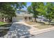 This lovely home showcases a well-manicured lawn, a two-car garage, and beautiful trees in the front yard at 5229 Nighthawk Pkwy, Brighton, CO 80601