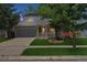 Charming two-story home featuring a well-maintained lawn, a covered front porch, and an attached two-car garage at 5229 Nighthawk Pkwy, Brighton, CO 80601