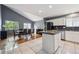 Bright eat-in kitchen with white cabinets, granite countertops, stainless steel appliances and a vaulted ceiling at 5229 Nighthawk Pkwy, Brighton, CO 80601