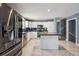 Spacious kitchen with stainless steel appliances, white cabinetry and granite countertops, and a center island at 5229 Nighthawk Pkwy, Brighton, CO 80601