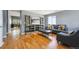 Cozy living room features hardwood floors, a decorative shelving unit and gray modern sofa at 5229 Nighthawk Pkwy, Brighton, CO 80601