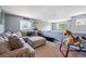 The living room is spacious, and includes a sofa and a rocking horse toy at 5229 Nighthawk Pkwy, Brighton, CO 80601