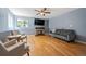Living area featuring wood floors, a fireplace, a flat-screen TV, and soft blue walls at 5229 Nighthawk Pkwy, Brighton, CO 80601