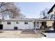 Cozy backyard showcasing a charming outdoor seating area and a well-maintained white brick exterior at 965 S Jersey St, Denver, CO 80224