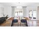 Elegant dining area featuring hardwood floors, a modern chandelier, and ample natural light at 965 S Jersey St, Denver, CO 80224