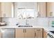 Modern kitchen with light wood cabinetry, stainless steel appliances, and herringbone tile backsplash at 965 S Jersey St, Denver, CO 80224