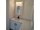 Bathroom featuring a modern vanity with quartz countertop and a framed mirror at 311 Elm St, Lochbuie, CO 80603