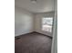 Cozy bedroom featuring soft carpeting and a bright window with neighborhood views at 311 Elm St, Lochbuie, CO 80603
