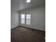Cozy bedroom with neutral walls, carpeting, and large windows at 311 Elm St, Lochbuie, CO 80603