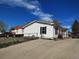 Charming single-story home with white siding, a well-maintained lawn, and a concrete driveway at 311 Elm St, Lochbuie, CO 80603