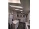 Kitchen featuring quartz countertops, bright skylight, and white cabinets at 311 Elm St, Lochbuie, CO 80603