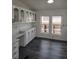 Bright kitchen with built-in desk, storage, and white cabinets at 311 Elm St, Lochbuie, CO 80603