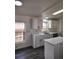 Bright kitchen with quartz countertops, stainless steel appliances, and an island at 311 Elm St, Lochbuie, CO 80603