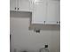 Functional laundry room with cabinets for storage and utility connections at 311 Elm St, Lochbuie, CO 80603