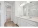 Bathroom with a double sink vanity, modern fixtures, and a walk-in shower at 6566 N Nepal St, Aurora, CO 80019