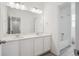 Bathroom with a double sink vanity, modern fixtures, and a walk-in shower at 6566 N Nepal St, Aurora, CO 80019