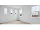 Bright, vacant bedroom featuring multiple windows that provide lots of natural light at 6566 N Nepal St, Aurora, CO 80019