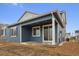 Inviting blue home featuring a cozy covered patio and sliding glass door, perfect for outdoor living at 6566 N Nepal St, Aurora, CO 80019