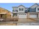 Charming new two-story home with attached two-car garage and yellow front door at 6566 N Nepal St, Aurora, CO 80019