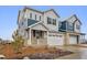 Charming new two-story home with attached two-car garage and cozy front porch at 6566 N Nepal St, Aurora, CO 80019