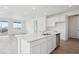 Modern kitchen featuring an island, stainless steel appliances, and lots of natural light at 6566 N Nepal St, Aurora, CO 80019
