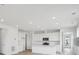 A modern kitchen with white cabinets, stainless steel appliances, and a central island at 6566 N Nepal St, Aurora, CO 80019