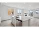Bright kitchen featuring an island and a large window overlooking the backyard at 6566 N Nepal St, Aurora, CO 80019