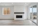 Bright living room featuring a modern fireplace and sliding glass door to the outside at 6566 N Nepal St, Aurora, CO 80019