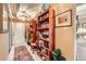 Hallway with tile flooring, a white door, and built-in wooden bookshelves at 7865 E Mississippi Ave # 304, Denver, CO 80247