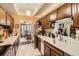 Functional kitchen with white countertops and a view into dining area at 7865 E Mississippi Ave # 304, Denver, CO 80247
