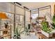 Inviting sunroom with city views, large plants, and shelving for storage at 7865 E Mississippi Ave # 304, Denver, CO 80247