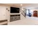 Large finished basement area featuring plush carpet, flat screen television, and staircase at 3367 New Haven Cir, Castle Rock, CO 80109